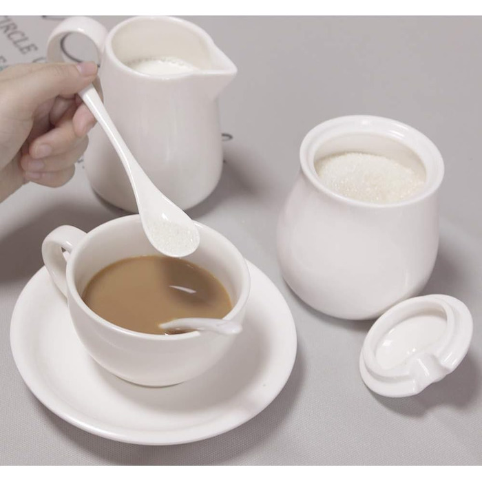 Cream-colored ceramic set for cream and sugar, coffee service, sugar bowl with lid and spoon, cream pitcher, creamer