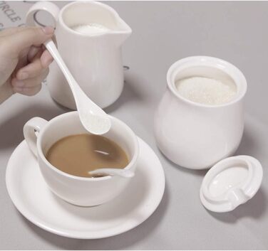 Cream-colored ceramic set for cream and sugar, coffee service, sugar bowl with lid and spoon, cream pitcher, creamer